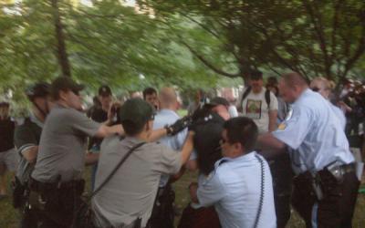 Rangers and Park Police fight to apprehend a protester after National Gathering attendees attempt to erect a tent at another Park Service site near Independence Hall. Photo by Joanne Michele