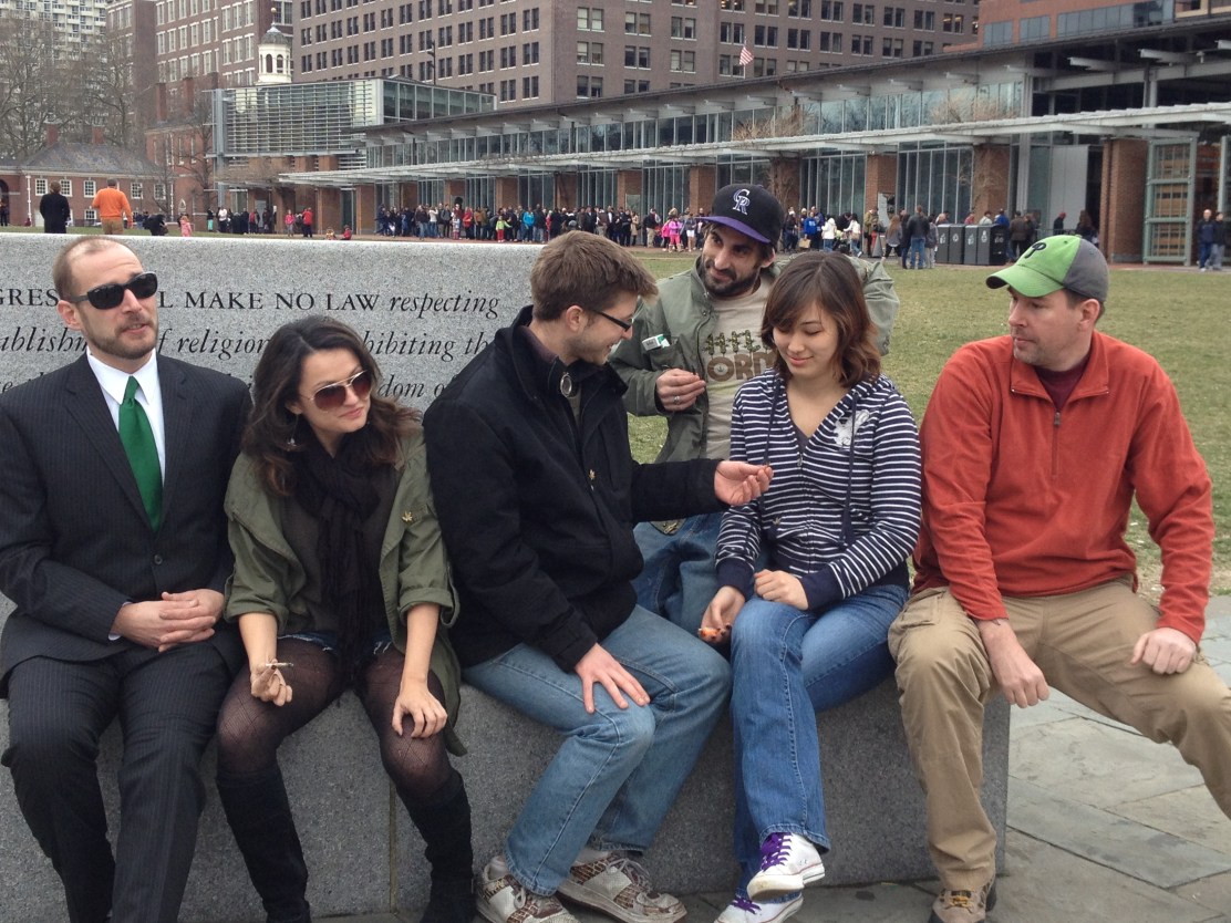 (Smokedown 'flash mob' demonstrating at Independence Mall, line of tourists to see the Liberty Bell in the background. Photo By Joanne Michele)