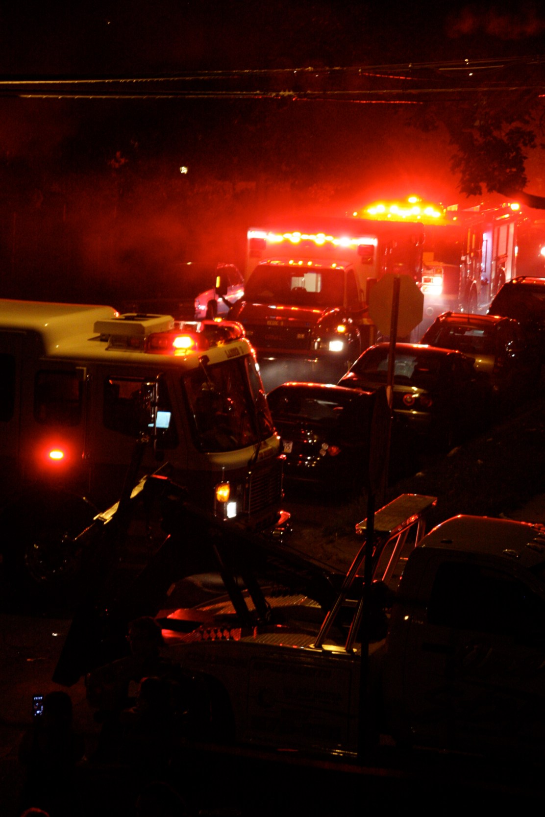 Several firetrucks and ambulances line the street to douse the flames, approximately 15 minutes after the collision. Photo by Kit Friday 