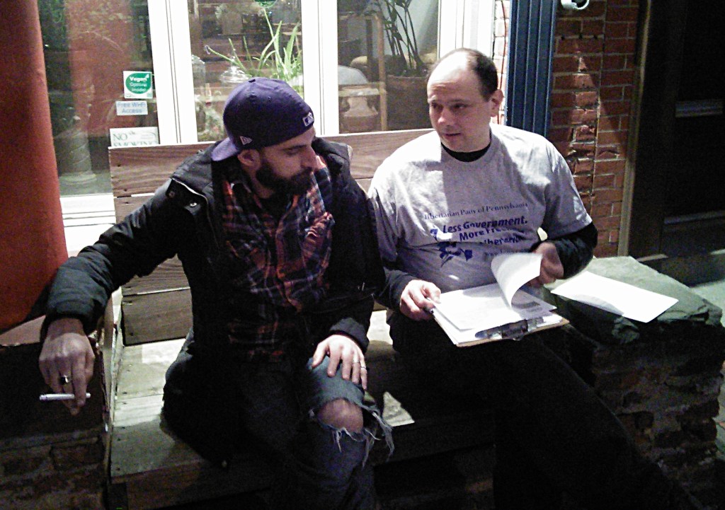 NA Poe goes over the nomination paperwork with Libertarian Party of Philadelphia Treasurer John Karr