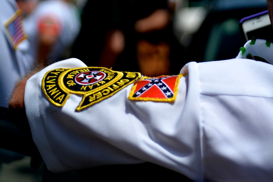 A white supremacist  waits for his fellow activist to join him for rally.  Photo by Joshua Albert