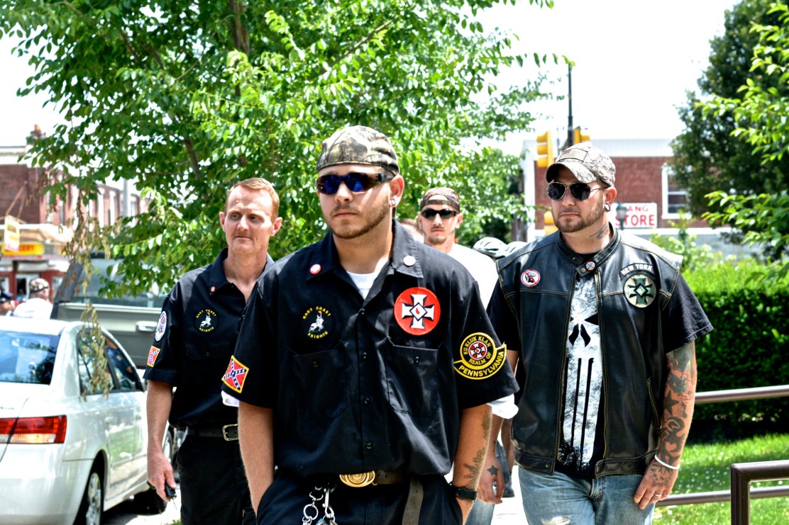 KKK members escorted from library. Photo by Joshua Albert