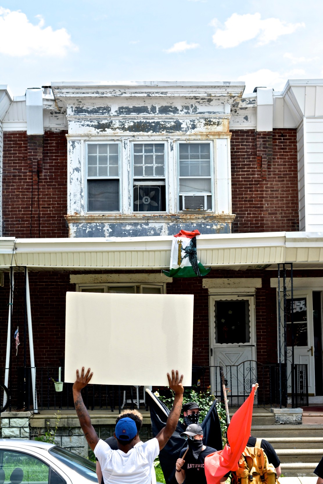 Tacony residents chant outside of the home of a reputed Neo-Nazi. Photo by Joshua Albert