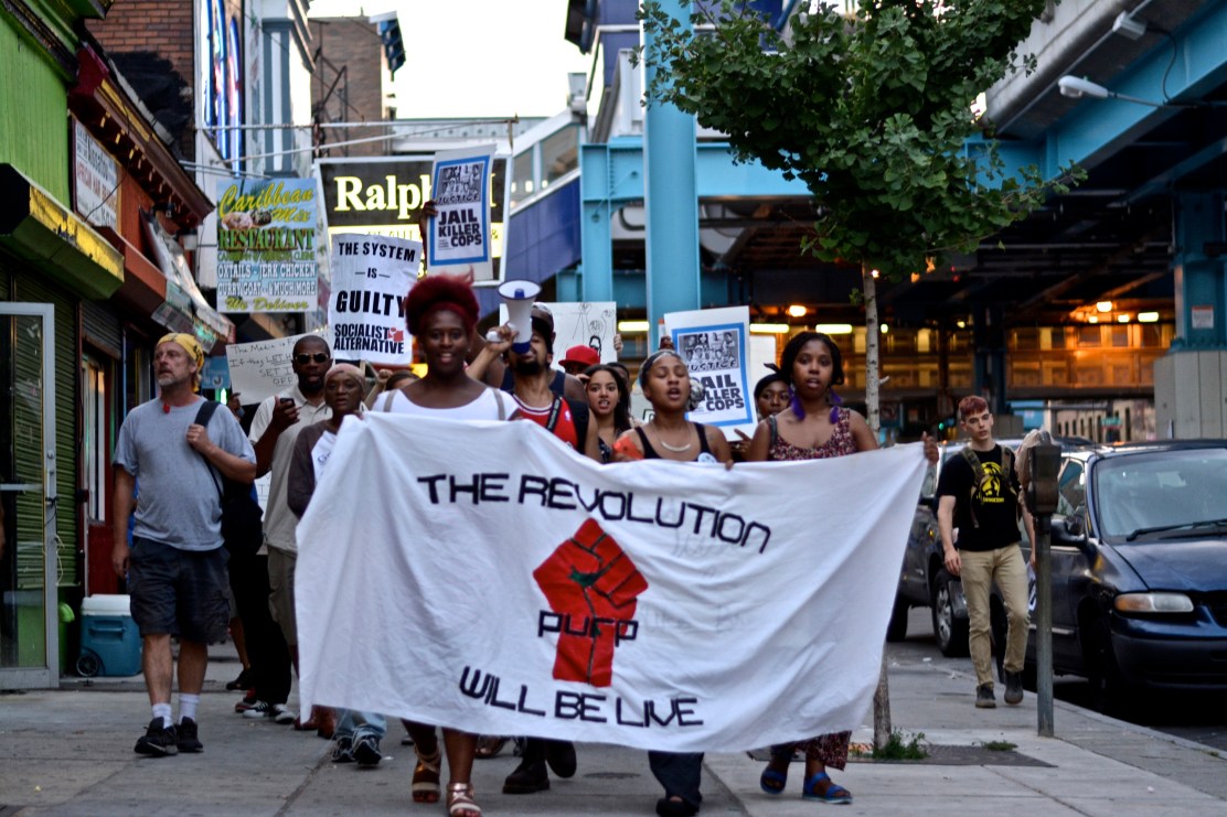 A march from 52nd and Market takes off down Market  St. 