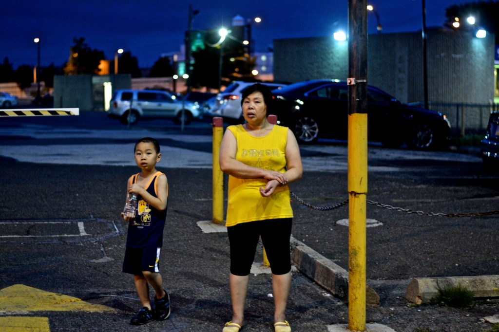 Bystanders watch as march to Philadelphia Police HQ goes by. 