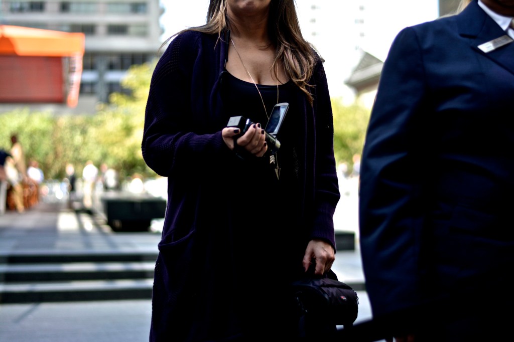 A Comcast security official videotapes demonstrators outside the company's headquarters. Photo: Joshua Albert