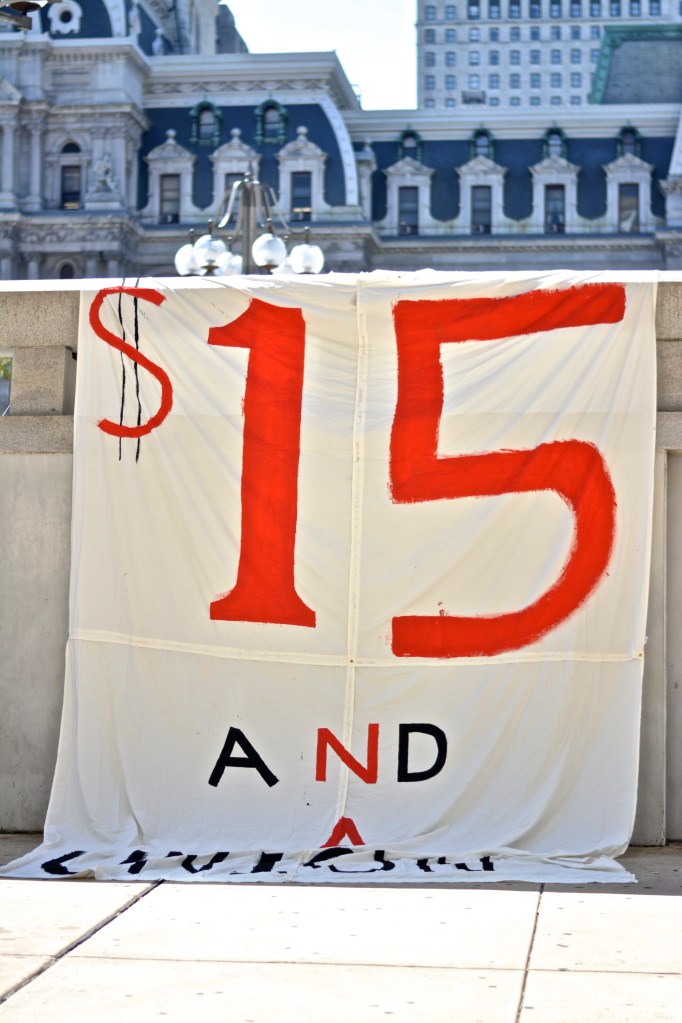 Protesters drop banner in front of Broad & Arch st McDonalds. 