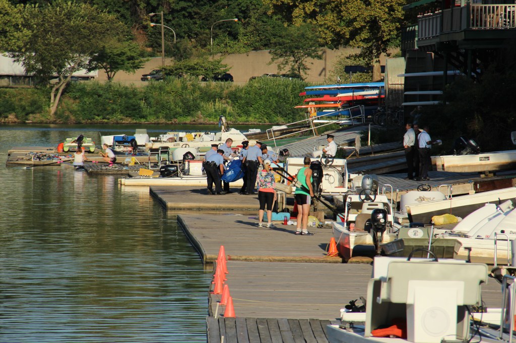Police carry the body to a police van waiting on Kelly Drive. Photo by Kenneth Lipp