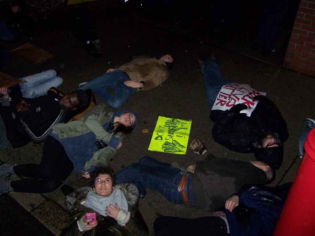 Protesters "die-in" in front of the South Street police station on Saturday Night